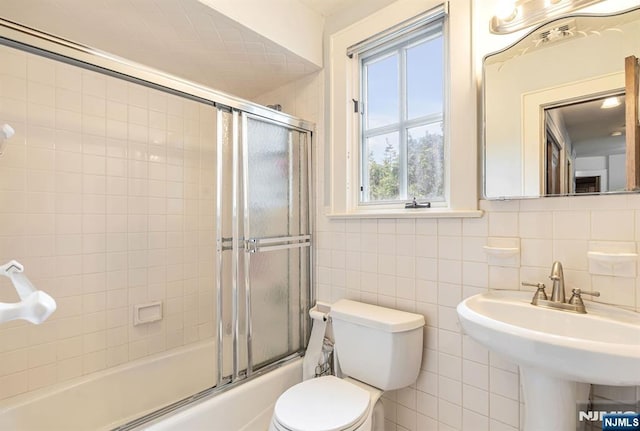 518 Standish Rd, Teaneck, NJ 07666 - full bathroom with bath / shower combo with glass door and tile walls