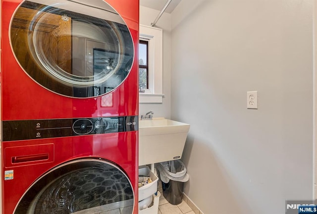 518 Standish Rd, Teaneck, NJ 07666 - washroom with estacked washer and dryer and tile patterned floors