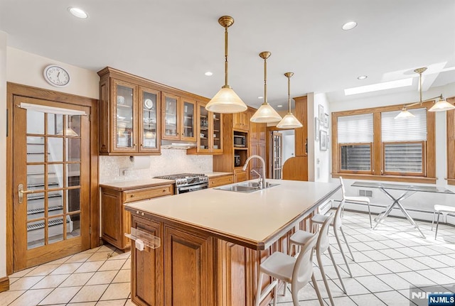 518 Standish Rd, Teaneck, NJ 07666 - kitchen with appliances with stainless steel finishes, light tile patterned floors, brown cabinets, light countertops, and a baseboard heating unit