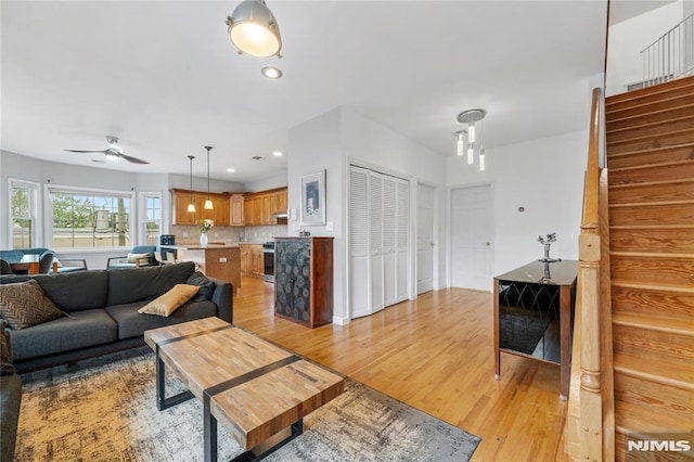 87 Centre St Unit 2, Nutley, NJ 07110 - living room with light wood-type flooring, stairs, ceiling fan, and recessed lighting