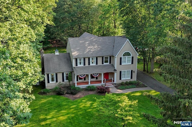 581 Eder Ave, Wyckoff, NJ 07481 - colonial home with a porch, a front yard, a shingled roof, and a chimney