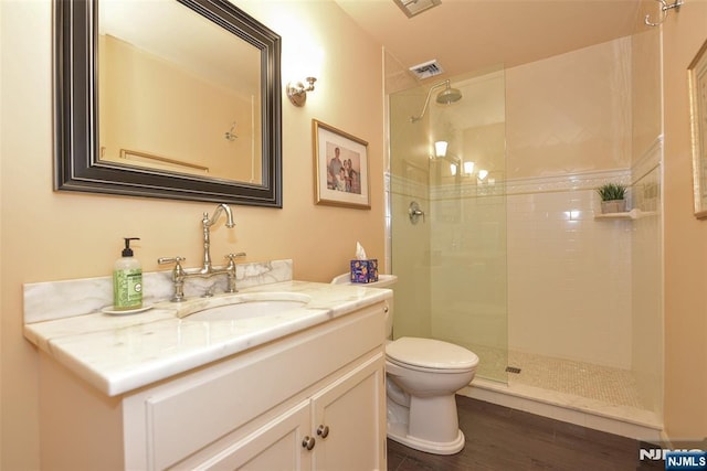 581 Eder Ave, Wyckoff, NJ 07481 - bathroom with vanity, a tile shower, and wood finished floors