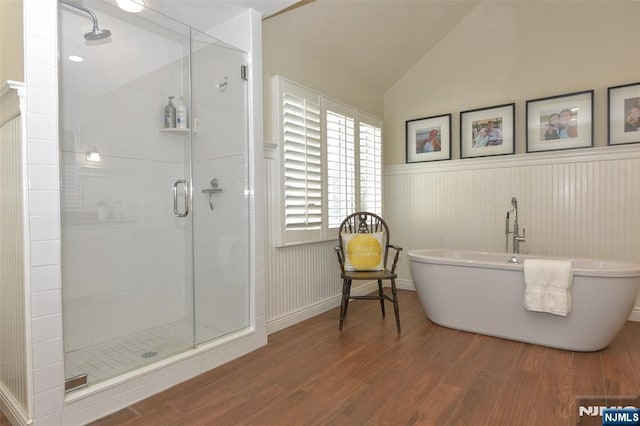 581 Eder Ave, Wyckoff, NJ 07481 - bathroom with wood finished floors, a stall shower, a freestanding bath, wainscoting, and lofted ceiling
