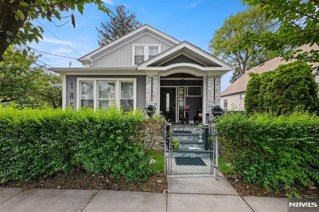 36 Kent, Newark, NJ 07108 - view of front of house with a gate, a fenced front yard, a porch, and board and batten siding