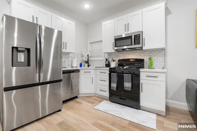 36 Kent, Newark, NJ 07108 - kitchen with stainless steel appliances, light countertops, white cabinetry, light wood-style flooring, and recessed lighting