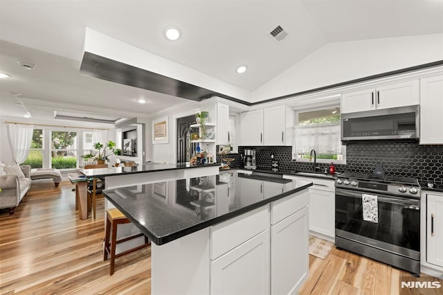 36 Kent, Newark, NJ 07108 - kitchen with appliances with stainless steel finishes, open floor plan, healthy amount of natural light, decorative backsplash, and vaulted ceiling