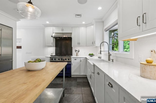 122 Howard Ter, Leonia, NJ 07605 - kitchen with high end appliances, under cabinet range hood, light countertops, recessed lighting, and white cabinets