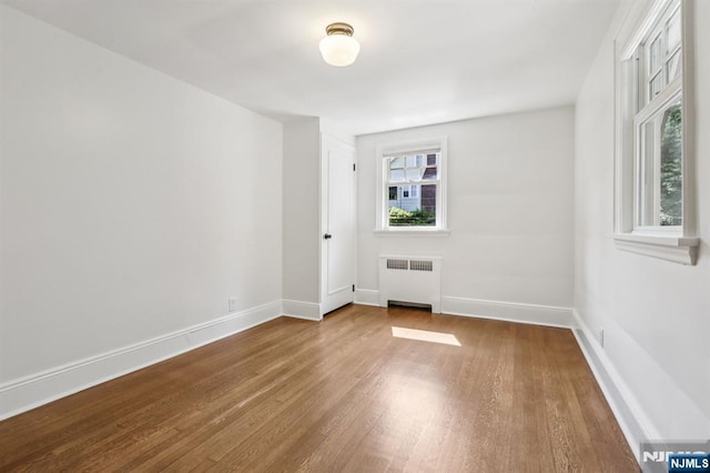 122 Howard Ter, Leonia, NJ 07605 - unfurnished room with radiator heating unit and wood finished floors