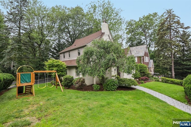 122 Howard Ter, Leonia, NJ 07605 - view of property exterior featuring a playground, a chimney, and stucco siding