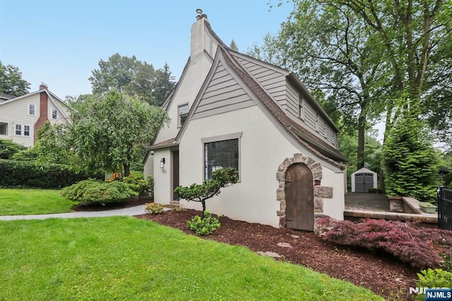 122 Howard Ter, Leonia, NJ 07605 - view of front facade featuring stucco siding, a chimney, and a front yard