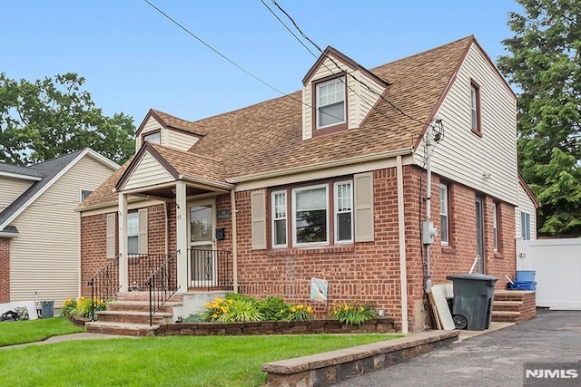 59 Parkview Ave, Elmwood Park, NJ 07407 - cape cod-style house with brick siding, roof with shingles, and a front yard