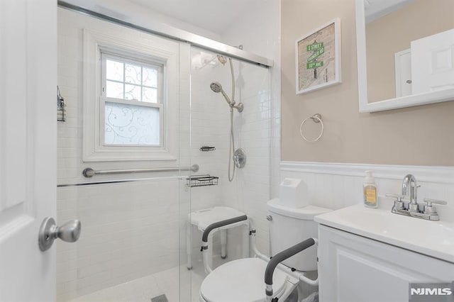 59 Parkview Ave, Elmwood Park, NJ 07407 - bathroom featuring a stall shower, a wainscoted wall, and vanity