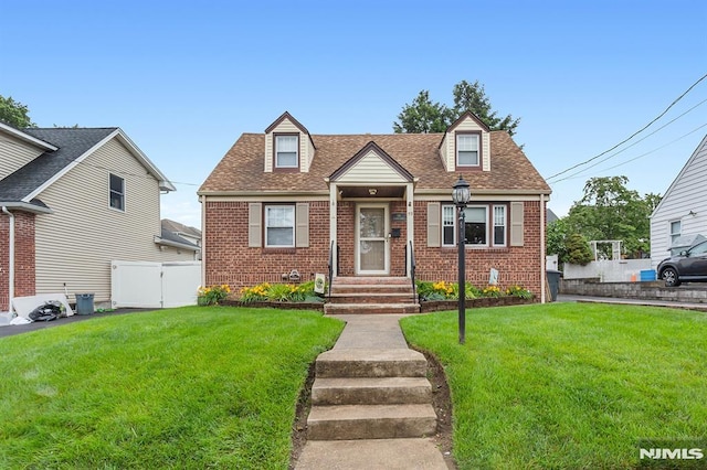 59 Parkview Ave, Elmwood Park, NJ 07407 - cape cod house with brick siding, a shingled roof, and a gate