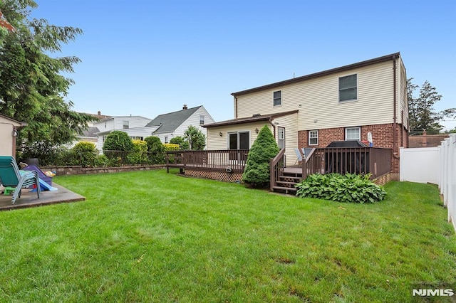 59 Parkview Ave, Elmwood Park, NJ 07407 - back of property with a fenced backyard, a deck, and brick siding