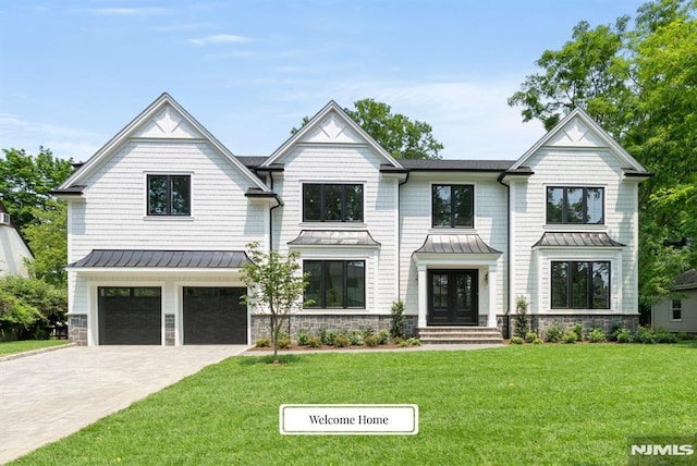 22 Northwood Ave, Demarest, NJ 07627 - view of front of home featuring a standing seam roof, an attached garage, driveway, and a front lawn