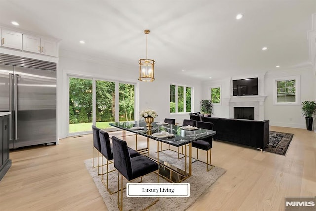 22 Northwood Ave, Demarest, NJ 07627 - dining area with recessed lighting, light wood-style floors, a fireplace, a chandelier, and crown molding