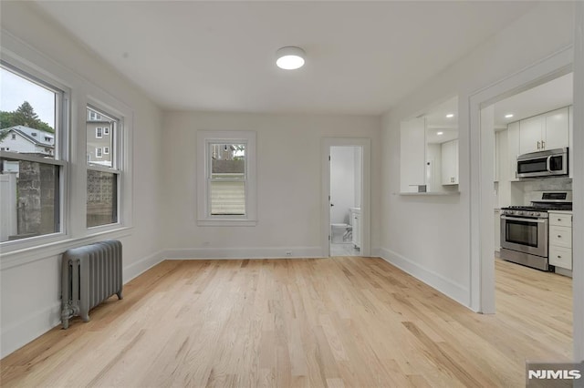 115 Wilson Ave, Rutherford, NJ 07070 - unfurnished living room with radiator heating unit and light wood-style flooring