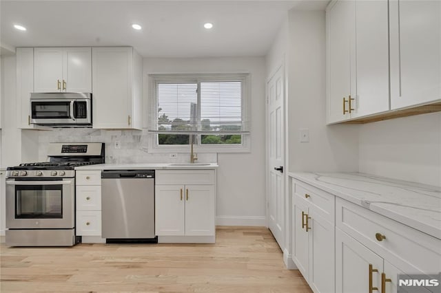 115 Wilson Ave, Rutherford, NJ 07070 - kitchen featuring stainless steel appliances, light wood-type flooring, recessed lighting, white cabinets, and tasteful backsplash