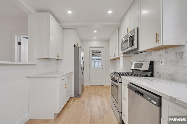 115 Wilson Ave, Rutherford, NJ 07070 - kitchen featuring stainless steel appliances, white cabinets, light wood-style floors, and recessed lighting