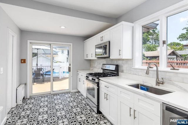 188 Wheaton Pl, Rutherford, NJ 07070 - kitchen featuring stainless steel appliances, plenty of natural light, white cabinets, recessed lighting, and tasteful backsplash