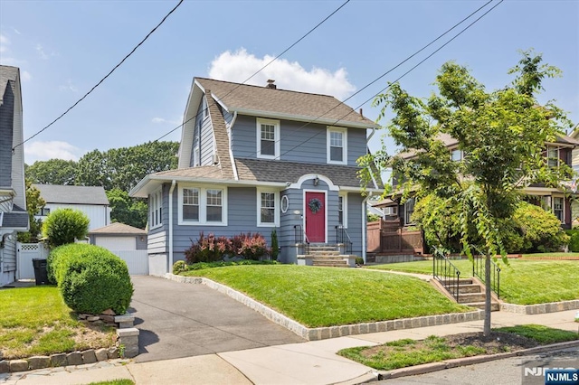 188 Wheaton Pl, Rutherford, NJ 07070 - view of front of house with an outbuilding, a shingled roof, a detached garage, and a front lawn