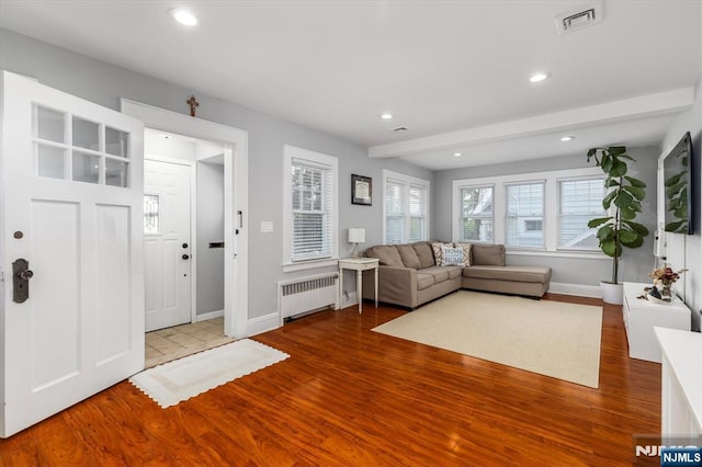 188 Wheaton Pl, Rutherford, NJ 07070 - living area with radiator heating unit, wood finished floors, recessed lighting, and beam ceiling