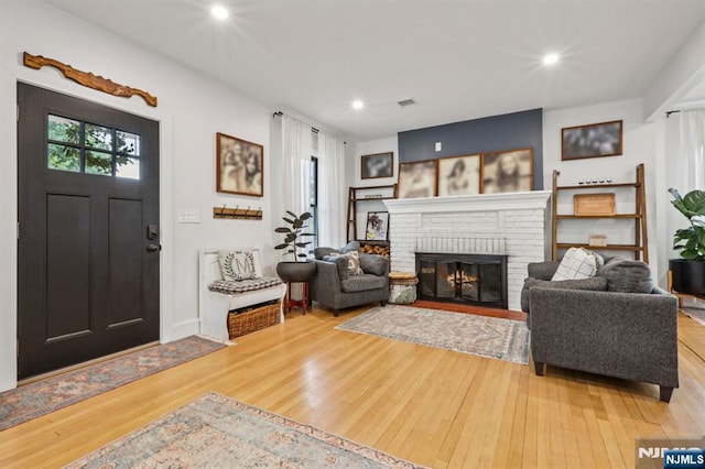 21 Mountainview Ave, Nutley, NJ 07110 - entryway with light wood-type flooring, a brick fireplace, and recessed lighting