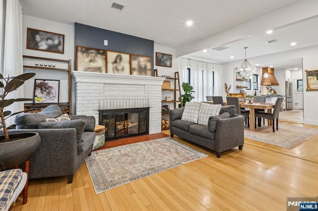 21 Mountainview Ave, Nutley, NJ 07110 - living area featuring light wood finished floors, a fireplace, a chandelier, and recessed lighting