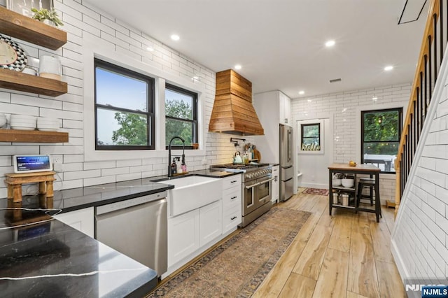 21 Mountainview Ave, Nutley, NJ 07110 - kitchen featuring appliances with stainless steel finishes, custom exhaust hood, white cabinetry, light wood-style flooring, and open shelves
