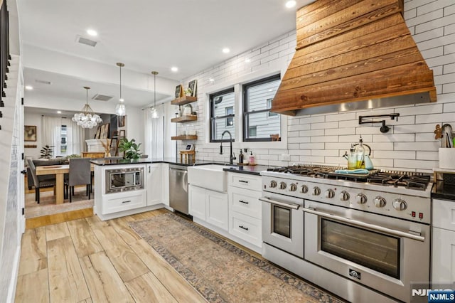 21 Mountainview Ave, Nutley, NJ 07110 - kitchen featuring appliances with stainless steel finishes, custom exhaust hood, dark countertops, white cabinets, and recessed lighting
