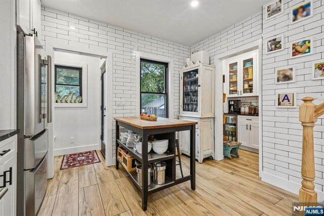 21 Mountainview Ave, Nutley, NJ 07110 - doorway featuring light wood finished floors, brick wall, and beverage cooler