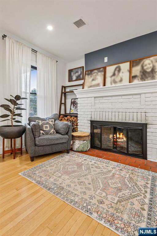 21 Mountainview Ave, Nutley, NJ 07110 - living room with a brick fireplace, hardwood / wood-style flooring, and recessed lighting