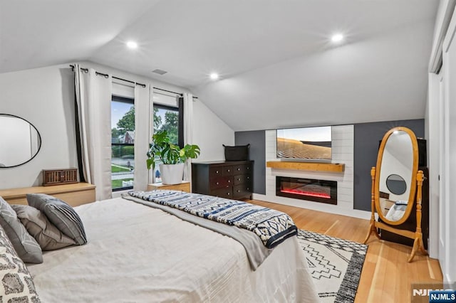 21 Mountainview Ave, Nutley, NJ 07110 - bedroom featuring vaulted ceiling, wood finished floors, recessed lighting, and a glass covered fireplace