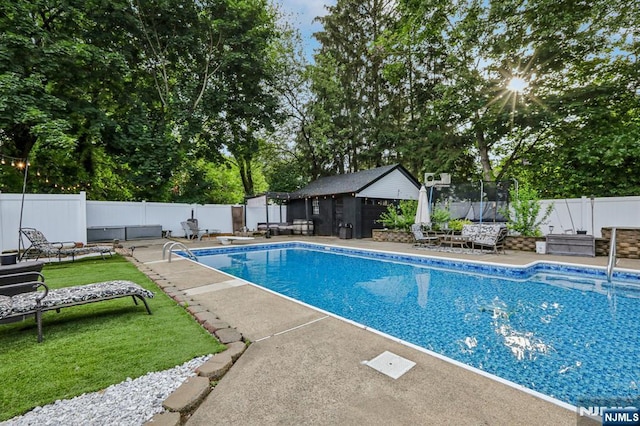 21 Mountainview Ave, Nutley, NJ 07110 - view of pool featuring a trampoline, a fenced backyard, an outbuilding, a patio, and view of scattered trees