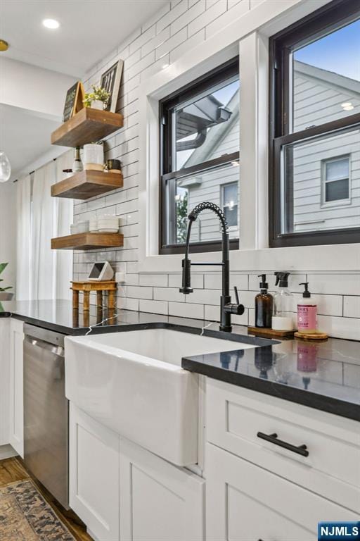 21 Mountainview Ave, Nutley, NJ 07110 - kitchen with stainless steel dishwasher, backsplash, plenty of natural light, and dark countertops