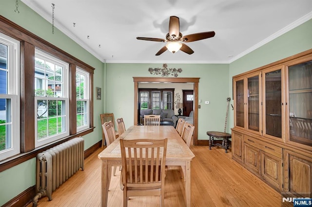 74 Bartholdi Ave, Butler Borough, NJ 07405 - dining room featuring radiator heating unit, light wood finished floors, a ceiling fan, and crown molding