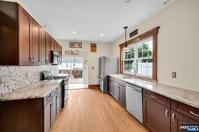 74 Bartholdi Ave, Butler Borough, NJ 07405 - kitchen featuring appliances with stainless steel finishes, light wood finished floors, healthy amount of natural light, tasteful backsplash, and recessed lighting
