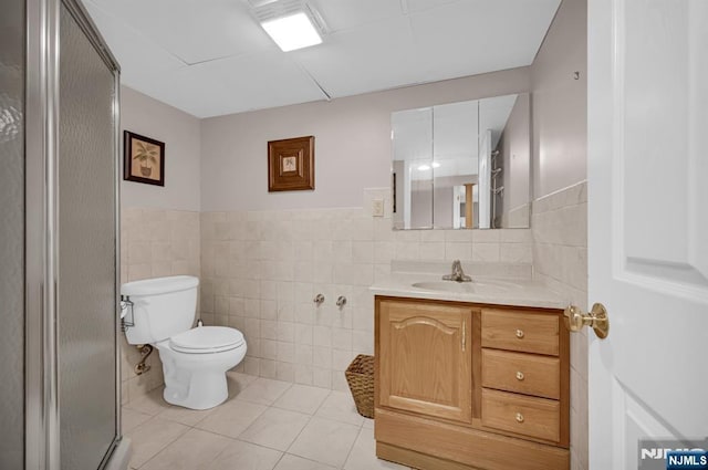 74 Bartholdi Ave, Butler Borough, NJ 07405 - full bathroom with tile walls, vanity, tile patterned flooring, a shower stall, and a wainscoted wall