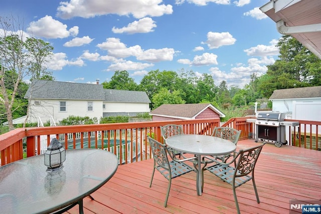 74 Bartholdi Ave, Butler Borough, NJ 07405 - wooden terrace featuring outdoor dining area, area for grilling, and a storage unit
