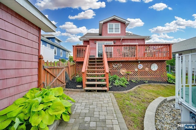 74 Bartholdi Ave, Butler Borough, NJ 07405 - view of play area with stairs, a wooden deck, and a gate