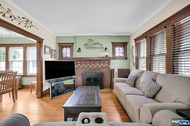 74 Bartholdi Ave, Butler Borough, NJ 07405 - living room with plenty of natural light, crown molding, light wood-style floors, and a brick fireplace