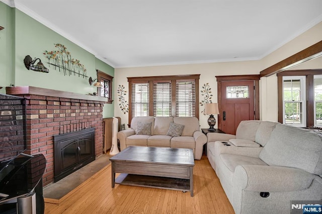 74 Bartholdi Ave, Butler Borough, NJ 07405 - living area featuring light wood-style floors, a brick fireplace, and ornamental molding