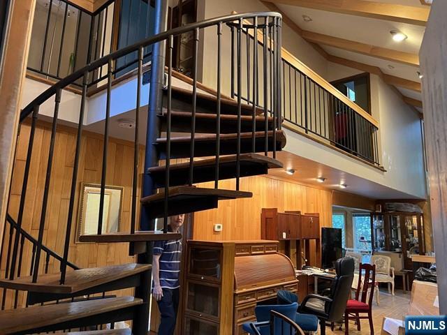 705 Sneider Ln, Franklin Lakes, NJ 07417 - staircase featuring a towering ceiling and wooden walls