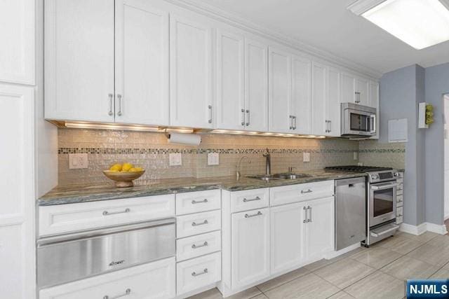 1600 Parker Ave Unit 1G, Fort Lee, NJ 07024 - kitchen featuring appliances with stainless steel finishes, dark stone countertops, white cabinetry, backsplash, and light tile patterned floors