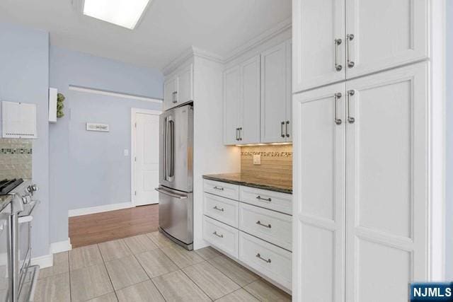 1600 Parker Ave Unit 1G, Fort Lee, NJ 07024 - kitchen featuring stainless steel appliances, backsplash, white cabinets, and dark stone counters