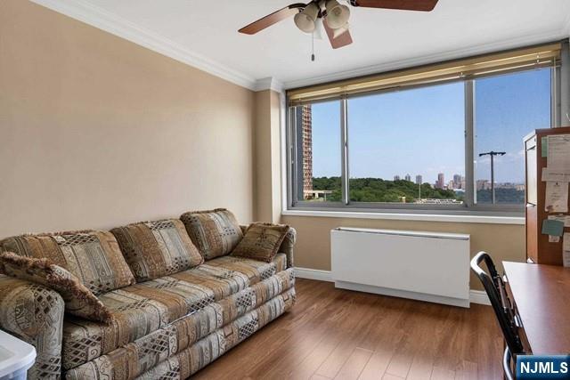 1600 Parker Ave Unit 1G, Fort Lee, NJ 07024 - living room with radiator heating unit, a ceiling fan, wood finished floors, and ornamental molding