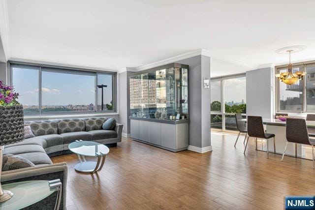 1600 Parker Ave Unit 1G, Fort Lee, NJ 07024 - living room featuring a chandelier, wood finished floors, floor to ceiling windows, and crown molding