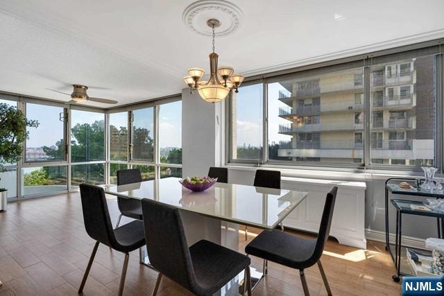 1600 Parker Ave Unit 1G, Fort Lee, NJ 07024 - dining area with floor to ceiling windows, wood finished floors, a chandelier, and a ceiling fan
