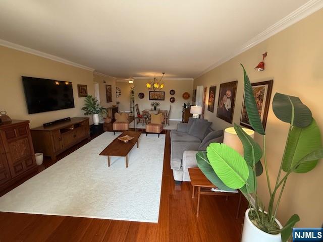 900 Palisade Unit 1-J, Fort Lee, NJ 07024 - living room with ornamental molding, a chandelier, and wood finished floors