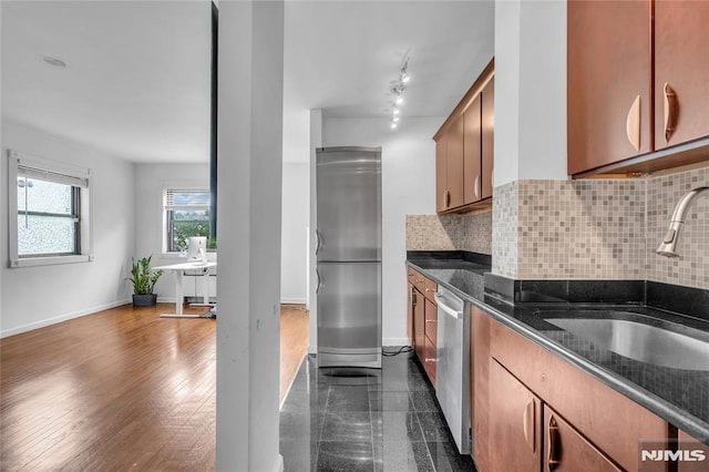 500 Linwood Dr Unit 5H, Fort Lee, NJ 07024 - kitchen featuring appliances with stainless steel finishes, decorative backsplash, dark stone countertops, brown cabinets, and an office area